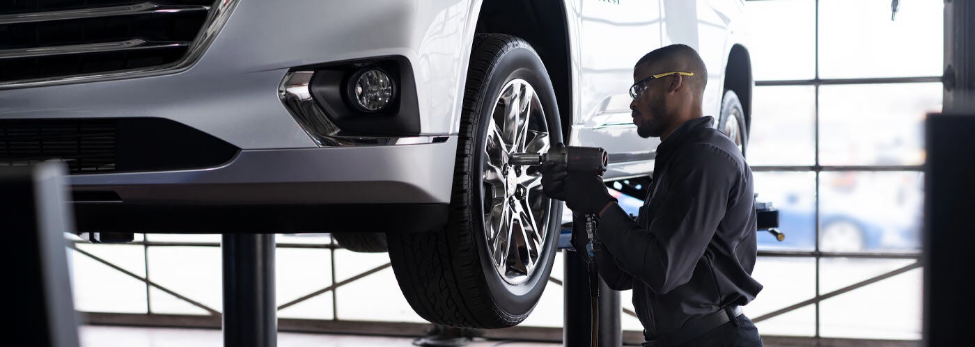 Chevy Mechanic Working on Tires